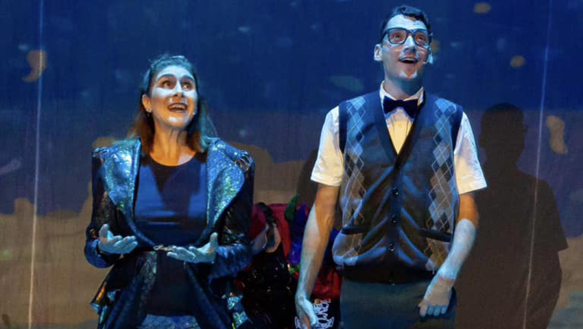 A woman and a man singing on stage in a theatre production